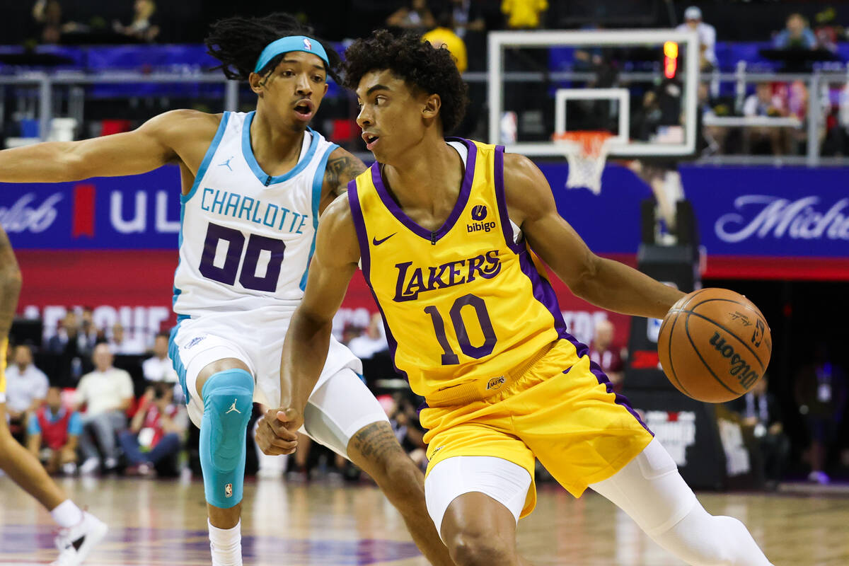 Los Angeles Lakers guard Max Christie (10) drives to the basket past Charlotte Hornets guard Ni ...