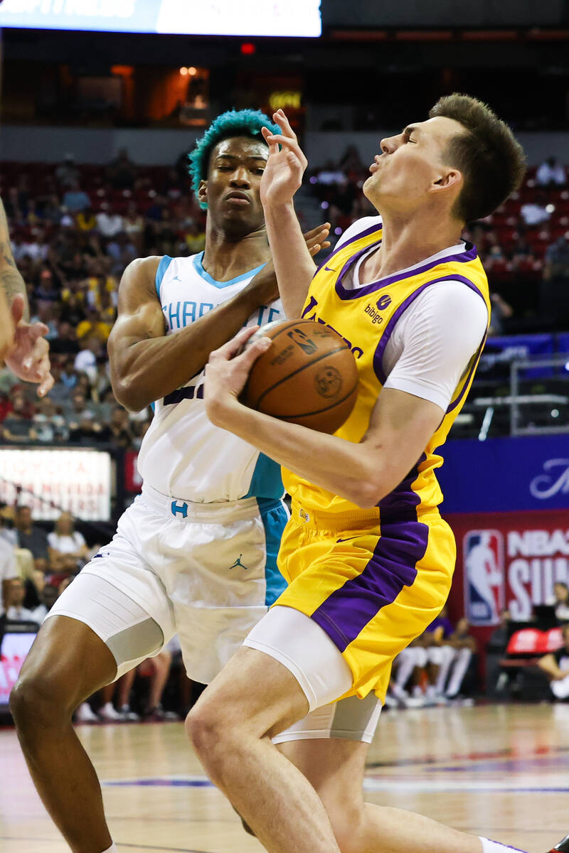 Los Angeles Lakers center Colin Castleton (26) is fouled by Charlotte Hornets forward/center Ka ...