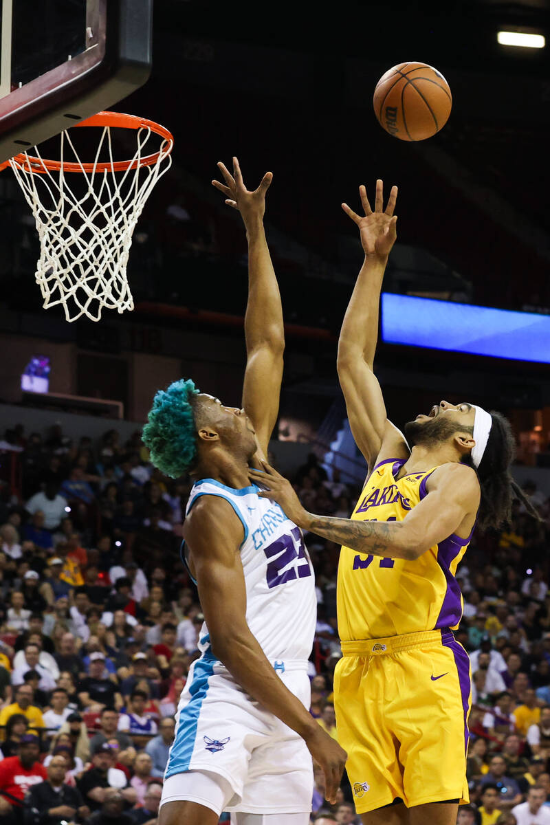 Los Angeles Lakers center Sacha Killeya-Jones (31) goes for a basket as Charlotte Hornets forwa ...