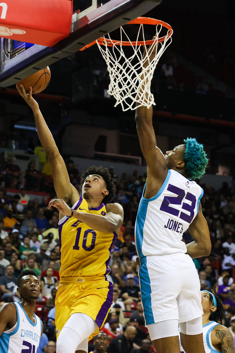 Los Angeles Lakers guard Max Christie (10) goes for a layup while Charlotte Hornets forward/cen ...