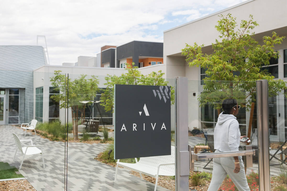A resident walks through one of the outdoor common spaces at the Ariva Luxury Residences on Fri ...