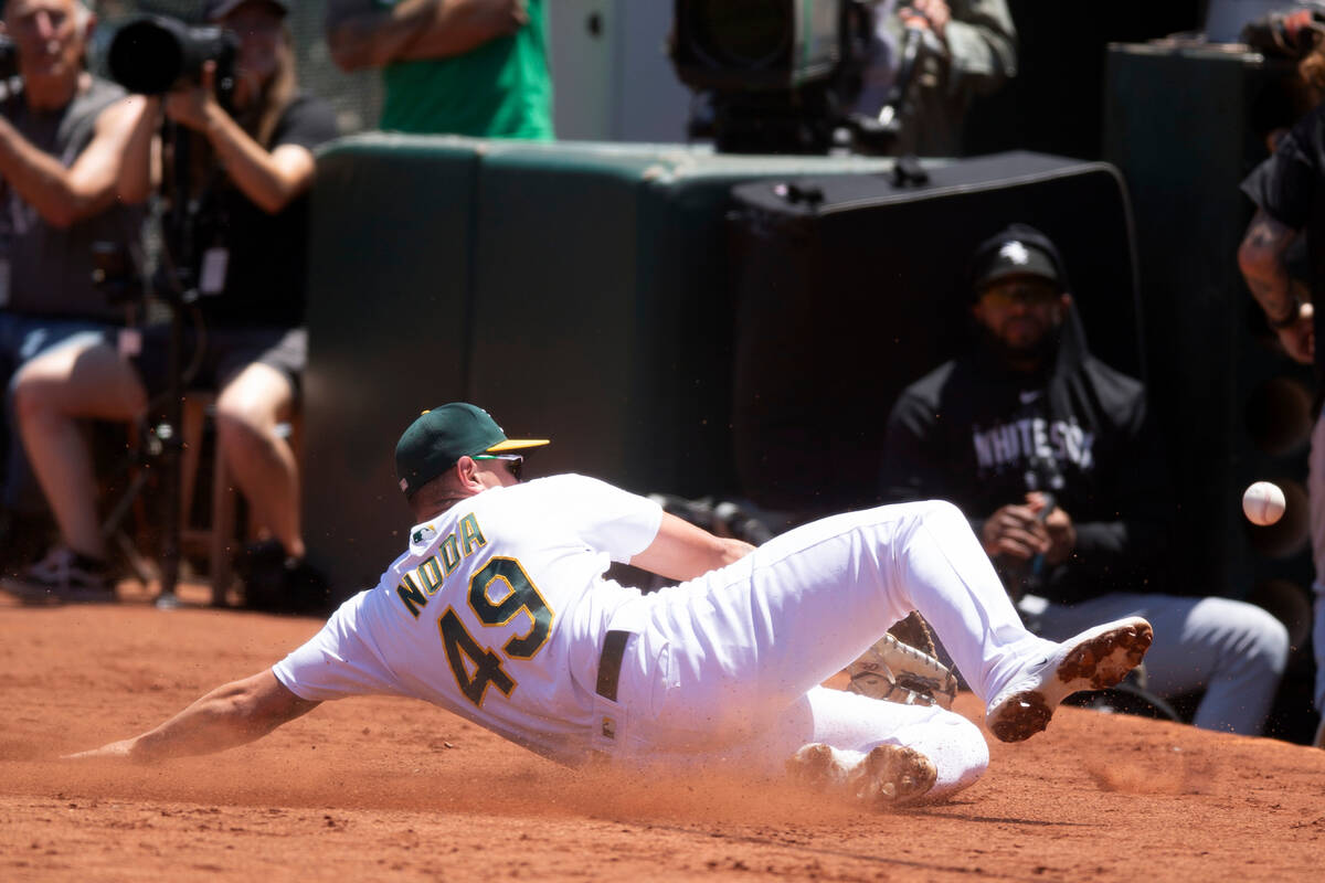 Oakland Athletics first baseman Ryan Noda (49) cannot make a sliding catch of a foul popup by C ...