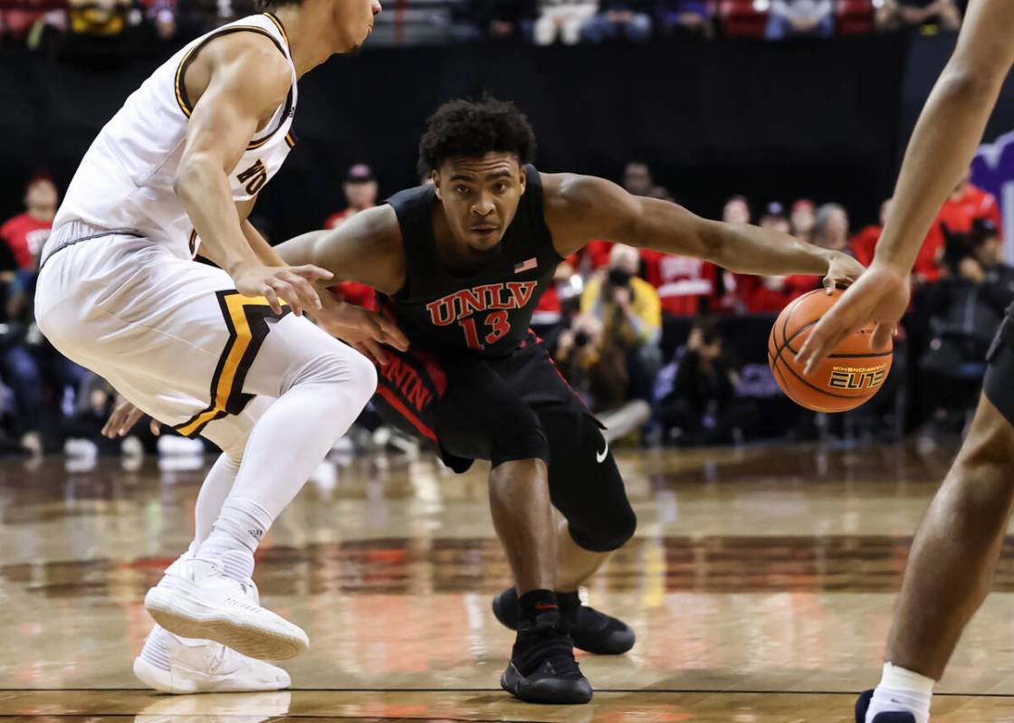 UNLV Rebels guard Bryce Hamilton (13) drives the ball against Wyoming Cowboys guard Brendan Wen ...