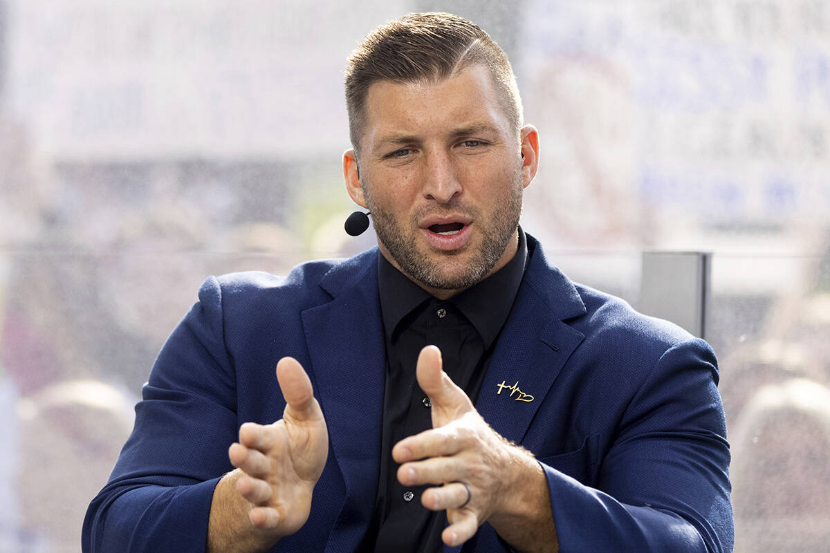 FILE - SEC Nation host Tim Tebow talks to his co-hosts during the SEC Nation broadcast in Lexin ...