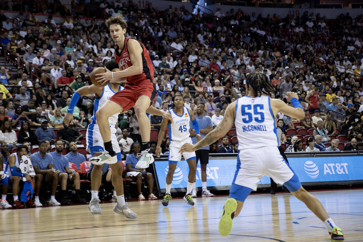 Houston Rockets forward Matthew Mayer, center left, jumps to snag his team’s rebound bef ...