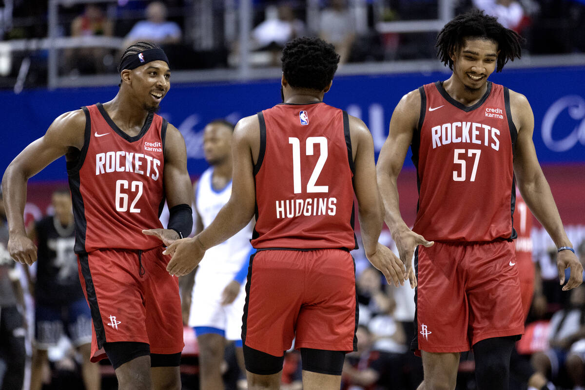 Houston Rockets guard Nate Hinton (62), guard Trevor Hudgins (12) and forward Jermaine Samuels ...
