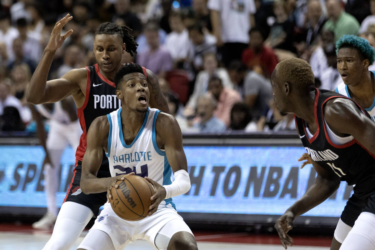Charlotte Hornets forward Brandon Miller (24) drives toward the hoop while guarded by Portland ...
