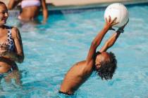 Ki Gleason-Jones catches a volleyball in the pool on Friday, June 30, 2023, at the Strat hotel ...