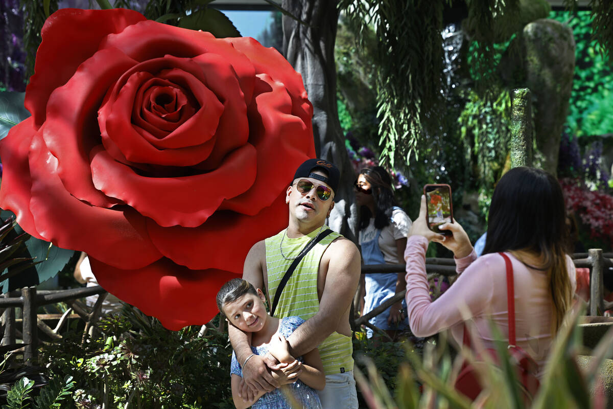 Ricard Lacarriere of Mexico poses for a photo with his daughter Eva, 9, as his sister Ariadna, ...