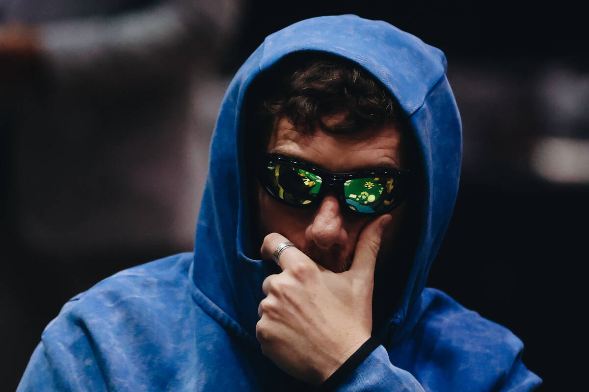 A poker table is reflected in the glasses of a poker player during the World Series of Poker $1 ...