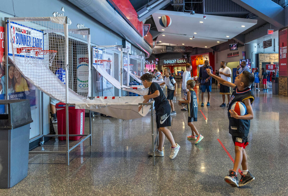 Fans shoot hoops in the concourse during the NBA Summer League at the Thomas and Mack Center on ...