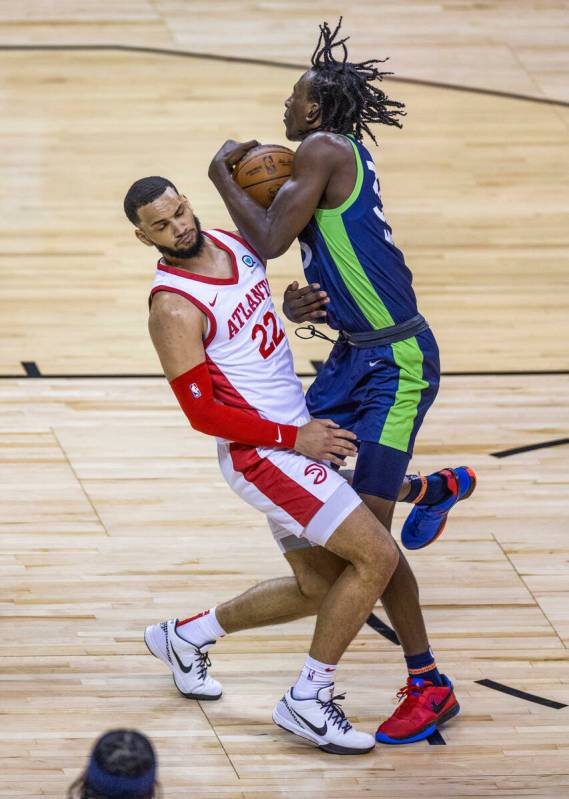 Atlanta Hawks guard Tyrese Martin (22) impedes the drive of Minnesota Timberwolves forward Leo ...