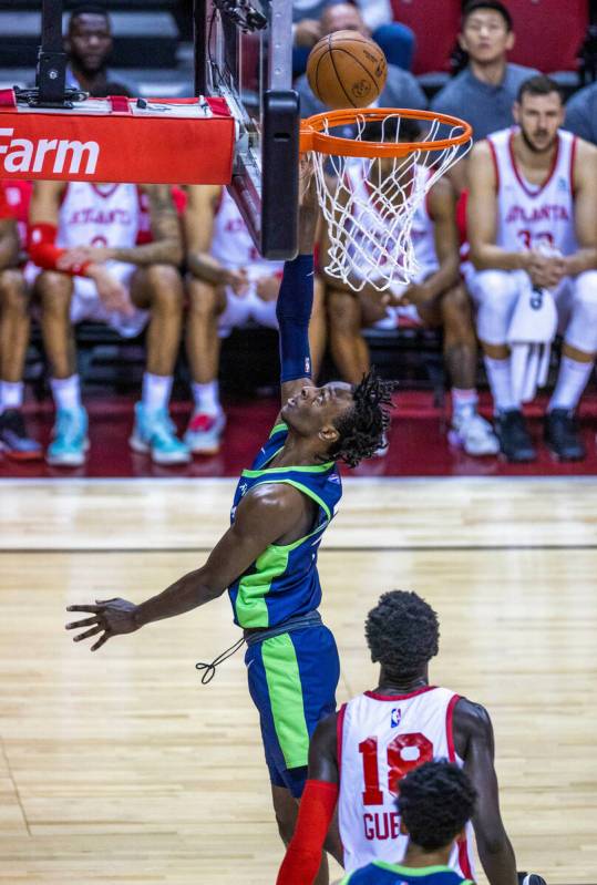 Minnesota Timberwolves forward Leonard Miller (33) scores over Atlanta Hawks forward Mouhamed G ...