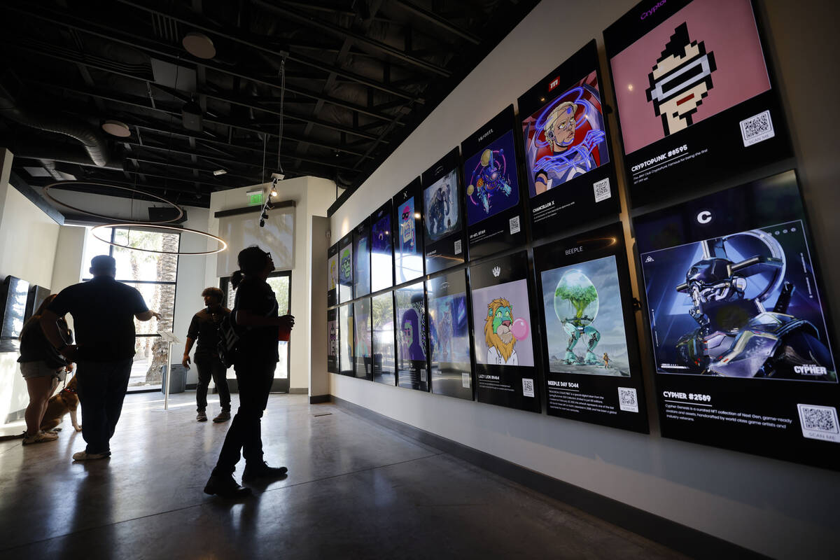 People look at NFT digital arts at JRNY Gallery, Friday, July 7, 2023, in Las Vegas. (Chitose S ...