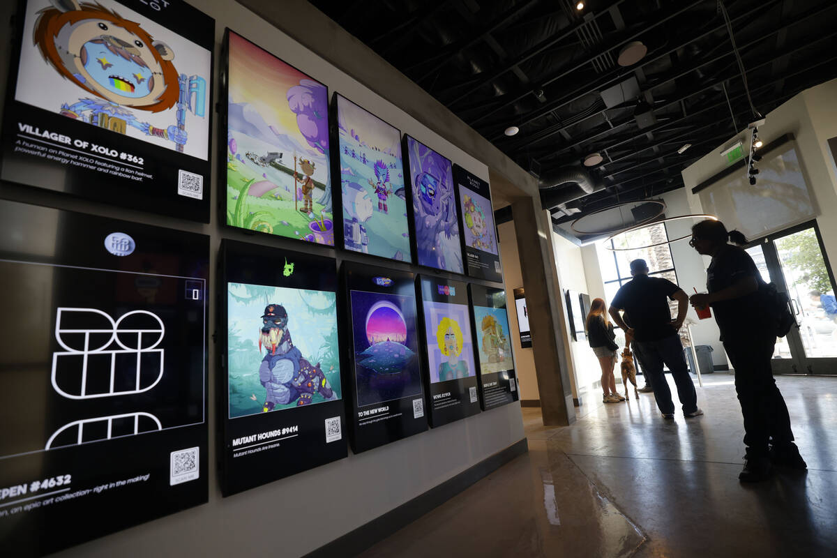 People look at NFT digital arts at JRNY Gallery, Friday, July 7, 2023, in Las Vegas. (Chitose S ...