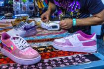 Colin Szumski attaches a custom pattern to a sneaker in the Majorwavez Lab booth on the concour ...