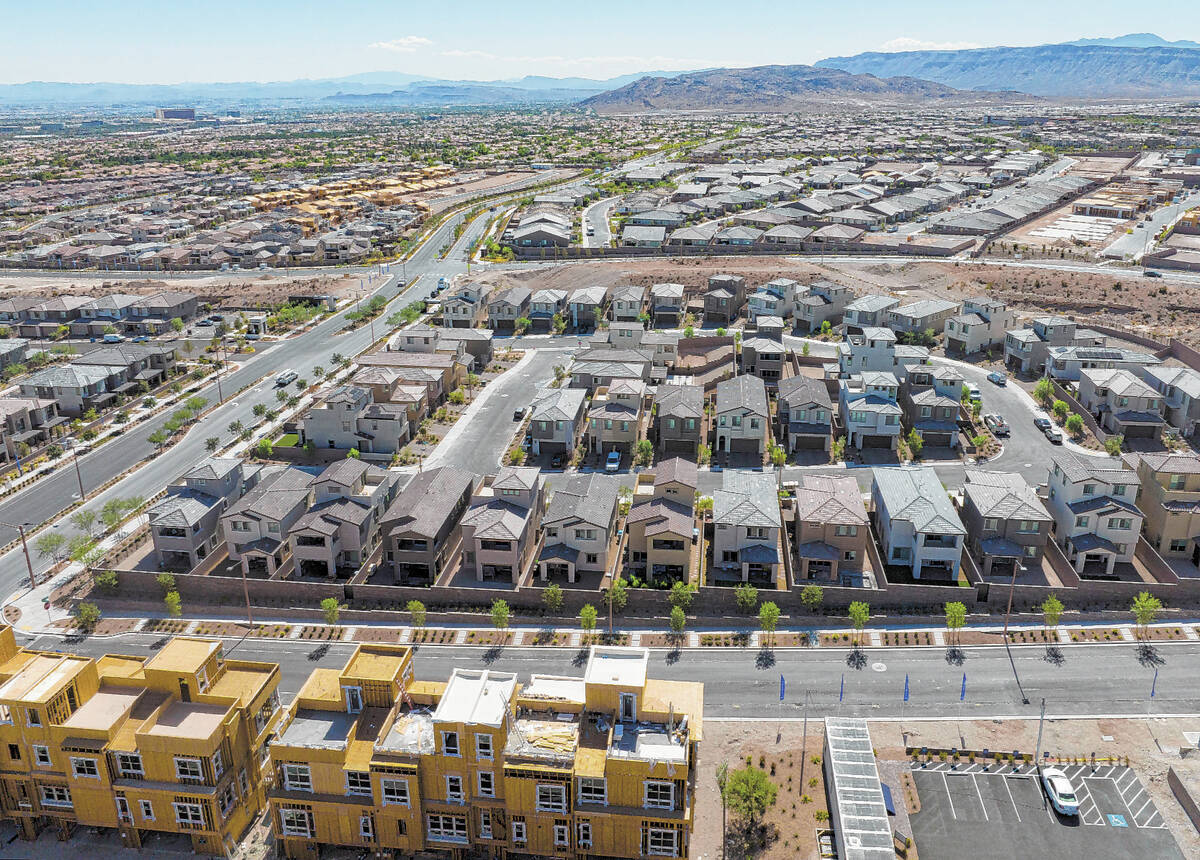 FILE - Construction is underway for new development as existing homes are seen from Desert Foot ...