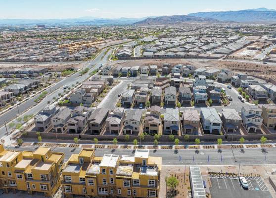 FILE - Construction is underway for new development as existing homes are seen from Desert Foot ...