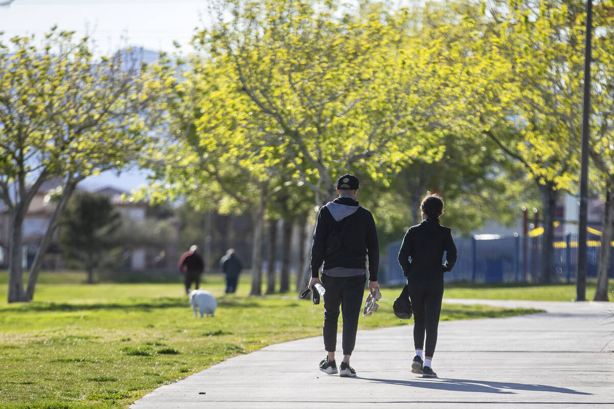 Las Vegas residents exercise on the relatively deserted paths at Desert Breeze Park on Friday, ...