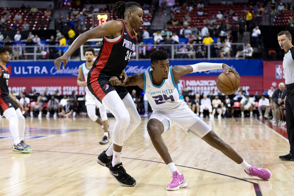 Charlotte Hornets forward Brandon Miller (24) dribbles around Portland Trailblazers forward Jab ...