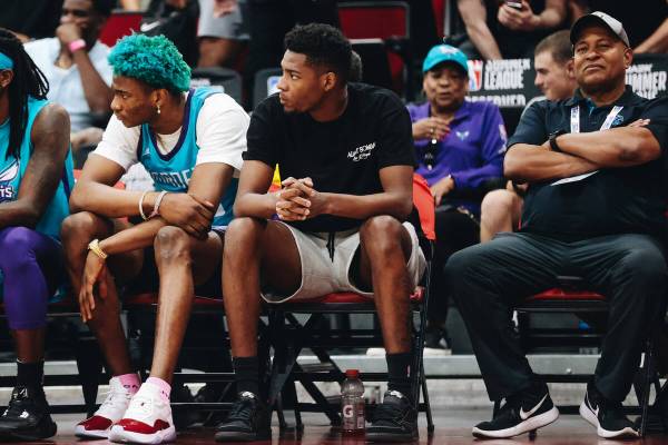 Charlotte Hornets forward Brandon Miller sits on the bench in his street clothes during an NBA ...