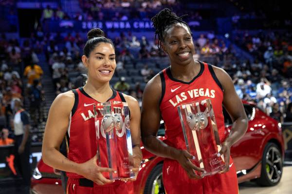 Las Vegas Aces guards Kelsey Plum, left, and Chelsea Gray pose with their trophies after winnin ...