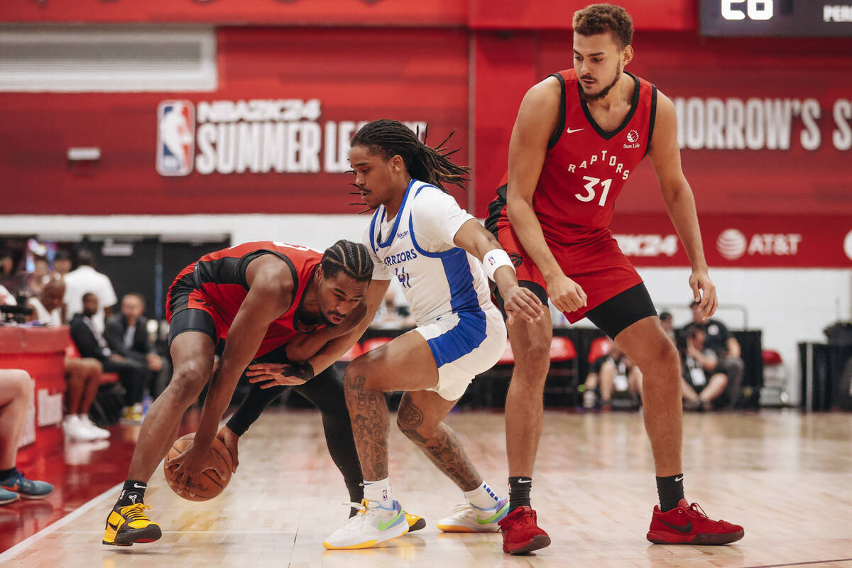 Toronto Raptors guard RJ Nembhard (12) fights to keep the ball in his posession as Golden State ...