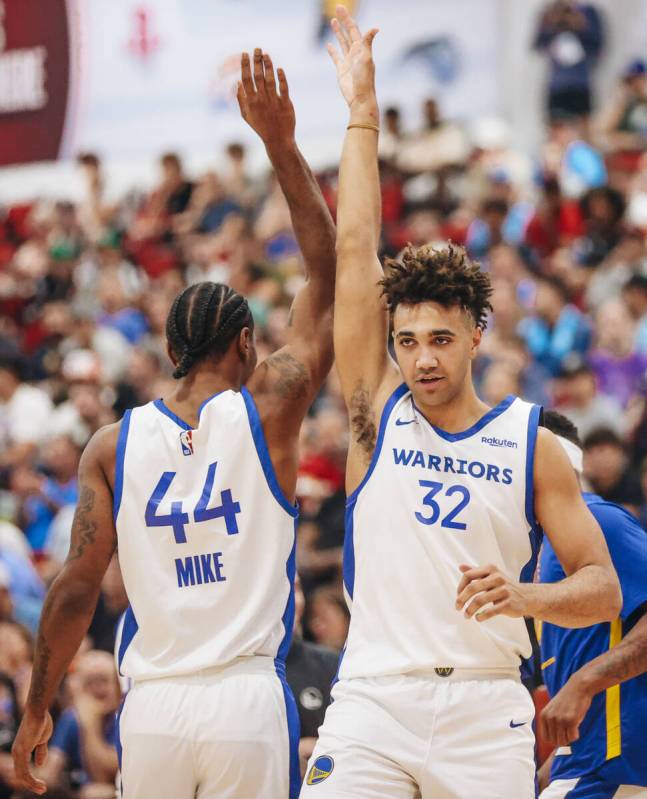 Golden State Warrior teammates Isiaha Mike (cq) (44) and Trayce Jackson-Davis (32) high-five ea ...