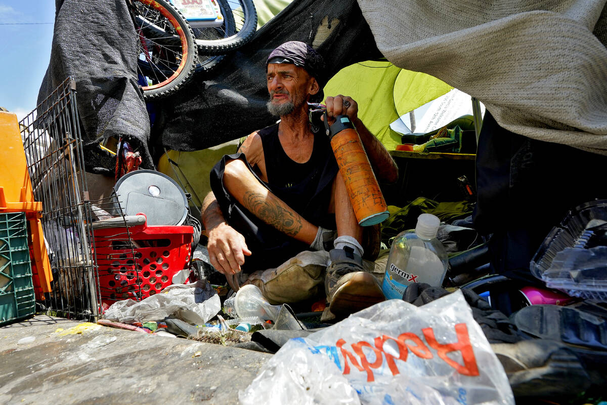 Charles Sanders, 59, sits in his tent inside a homeless encampment called "The Zone," ...