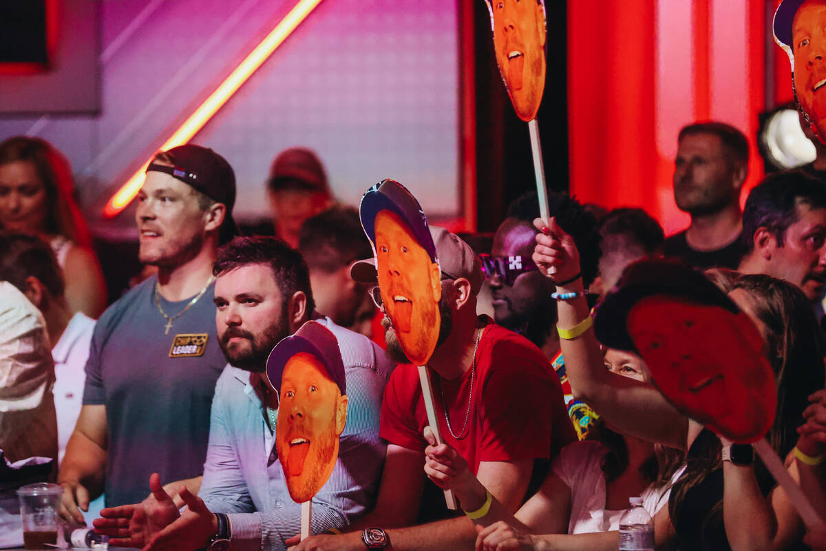 Cutouts of Steven Jones are held up by supporters during the $10,000 buy-in No-limit Hold&#x201 ...