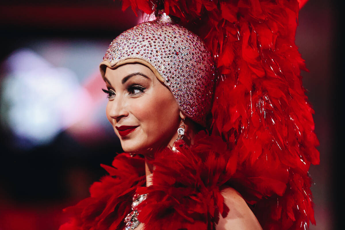 A showgirl smiles before the beginning of the $10,000 buy-in No-limit Hold’em World Cham ...