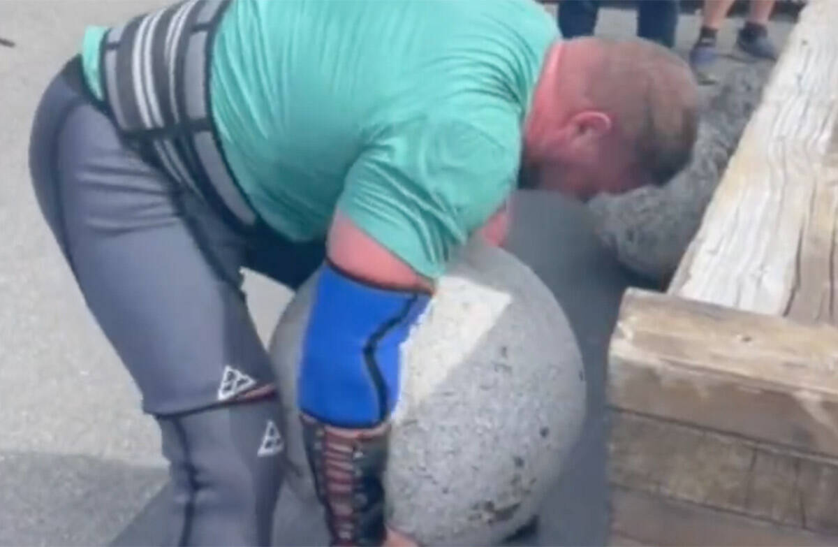 Metropolitan Police Officer James Rude lifts a rock during a weightlifting competition in Fefor ...