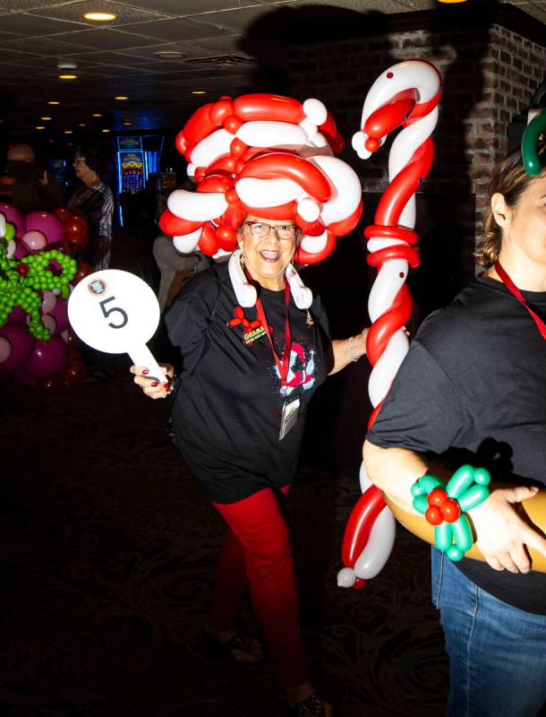 Balloon artist “Grama V” of Sacramento, Calif., walks through Binion’s bef ...