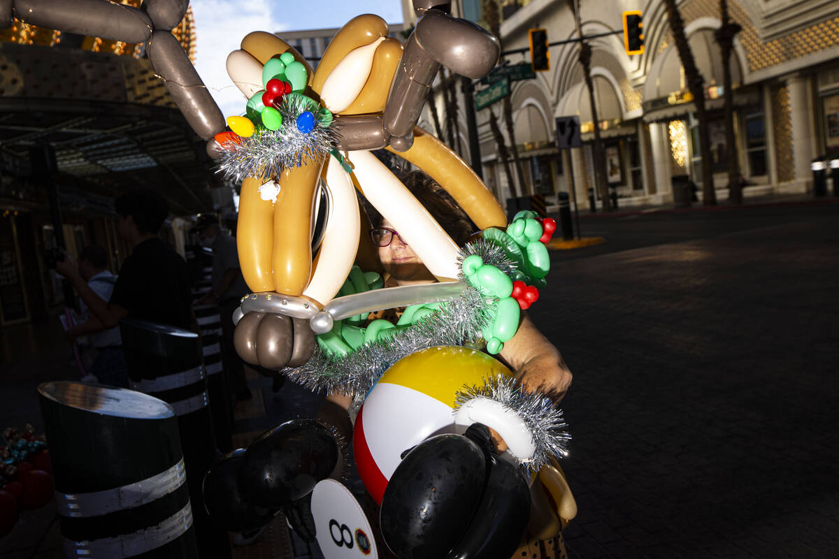 Attendees of the Bling Bling Jam balloon convention participate in a parade along the Fremont S ...