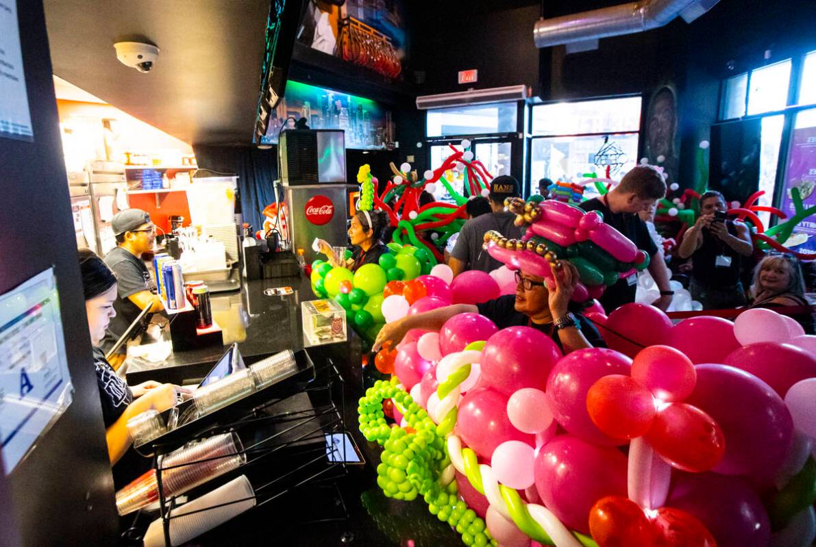 Attendees of the Bling Bling Jam balloon convention stop for refreshments after their parade al ...