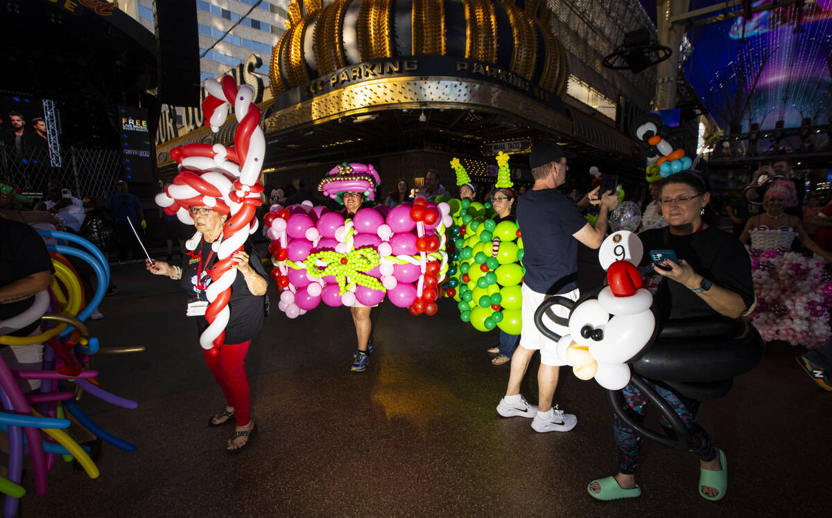 Attendees of the Bling Bling Jam balloon convention participate in a parade along the Fremont S ...