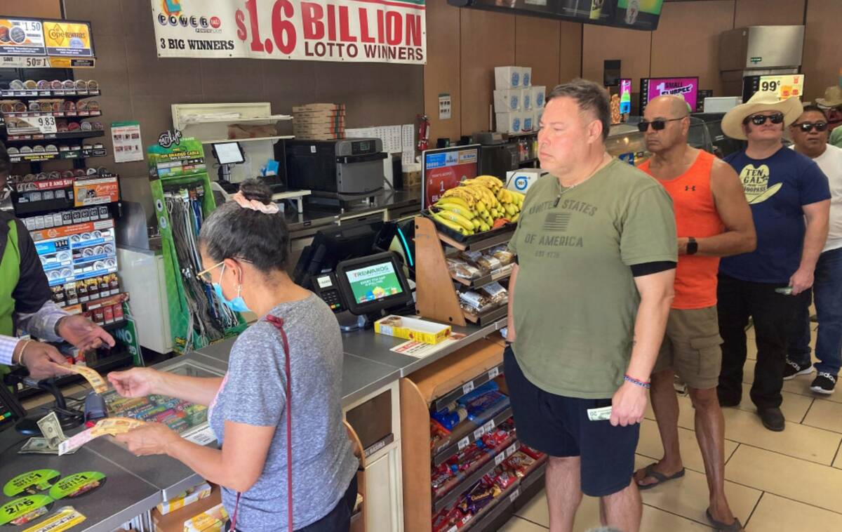 People line up to buy Powerball tickets at a 7 Eleven liquor store on Wednesday, July 19, 2023, ...