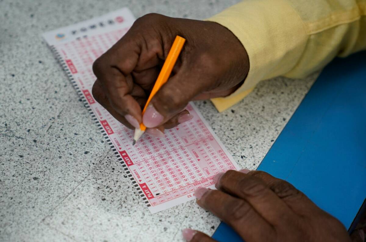 A customer fills out a Powerball ticket, Wednesday, July 19, 2023, in Hawthorne, Calif. (AP Ph ...