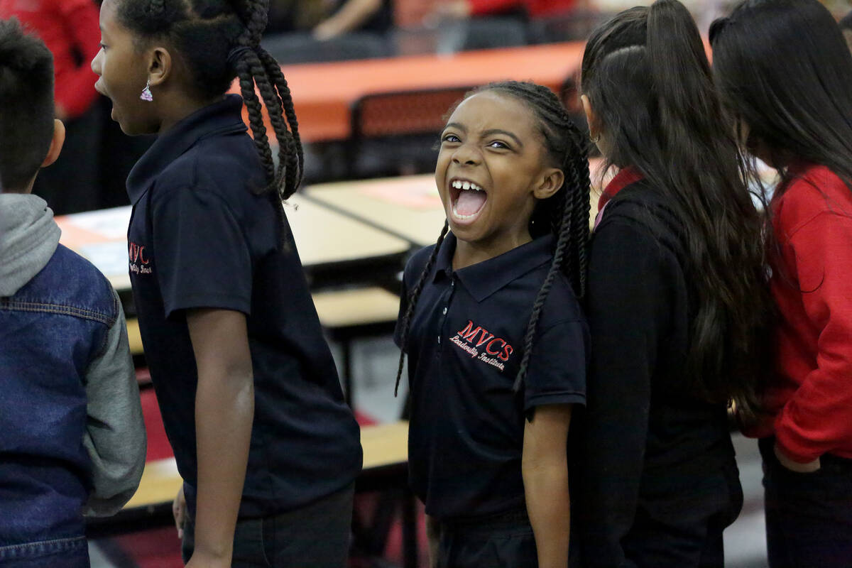 Jaraya Crosby, 7, waits in line during a Thanksgiving potluck at Mountain View Christian School ...