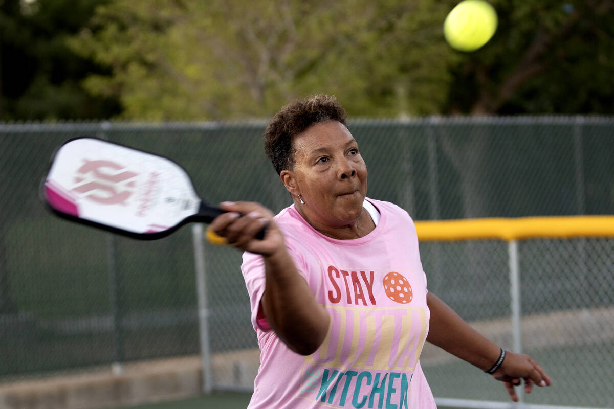 Neon Pickler Diane Hardy sets up to whack the ball during a pickleball match at Aloha Shores Pa ...