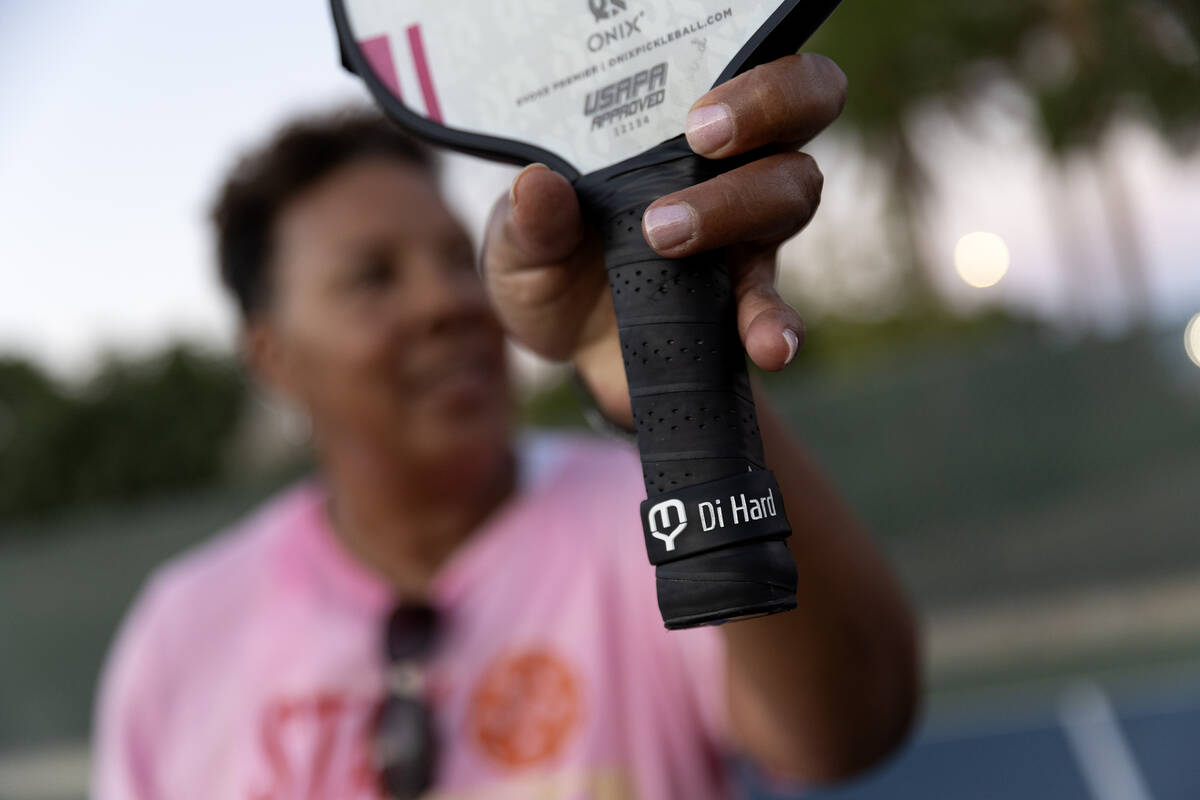 Neon Pickler Diane Hardy, nicknamed “Di Hard,” shows her monogrammed racket after her pickl ...