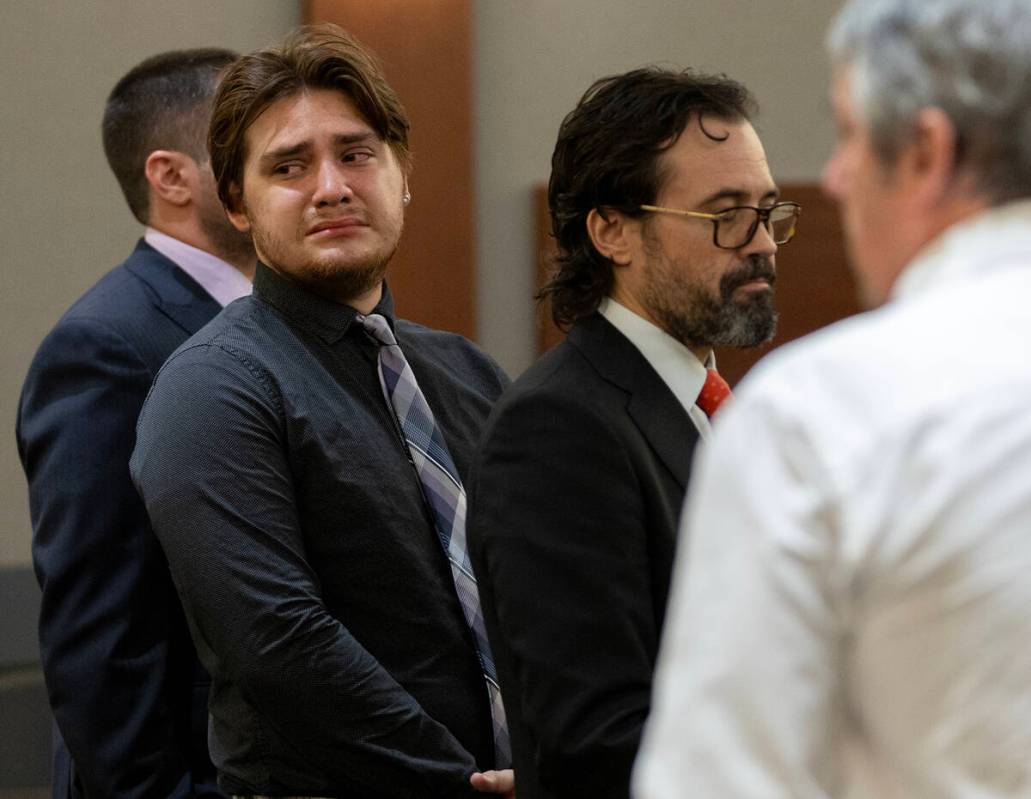 Angelo Loza, left, looks toward his family after Tom Steyer, right, father of Louis Steyer, gav ...