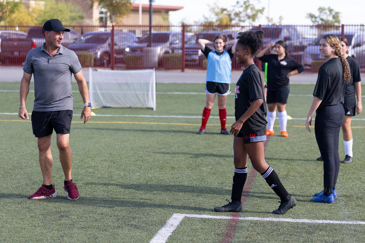 FILE - Soccer coach Kurt Divich talks to his players during a girls team practice at Doral Acad ...