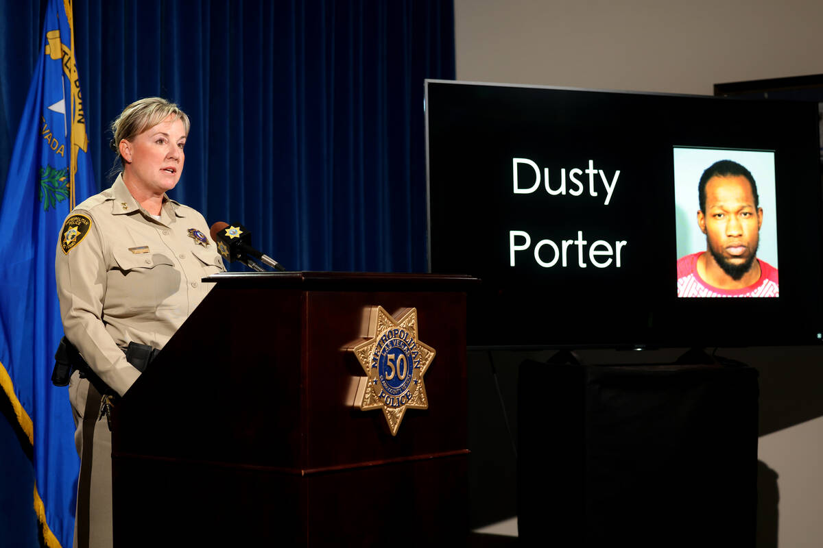 Assistant Sheriff Jamie Prosser shows a photo of suspect Dusty Porter during a news media confe ...