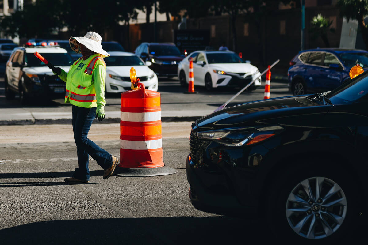 A person directs traffic while the street is under construction for the Formula One Las Vegas G ...