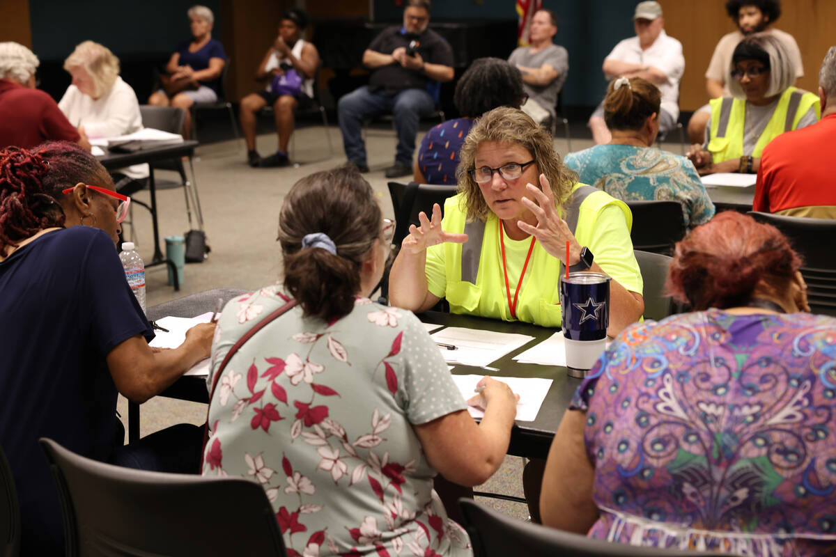 Connie Ames with All City Management Services helps, from left, Ann Rhodes, Karen Trinko and Pa ...