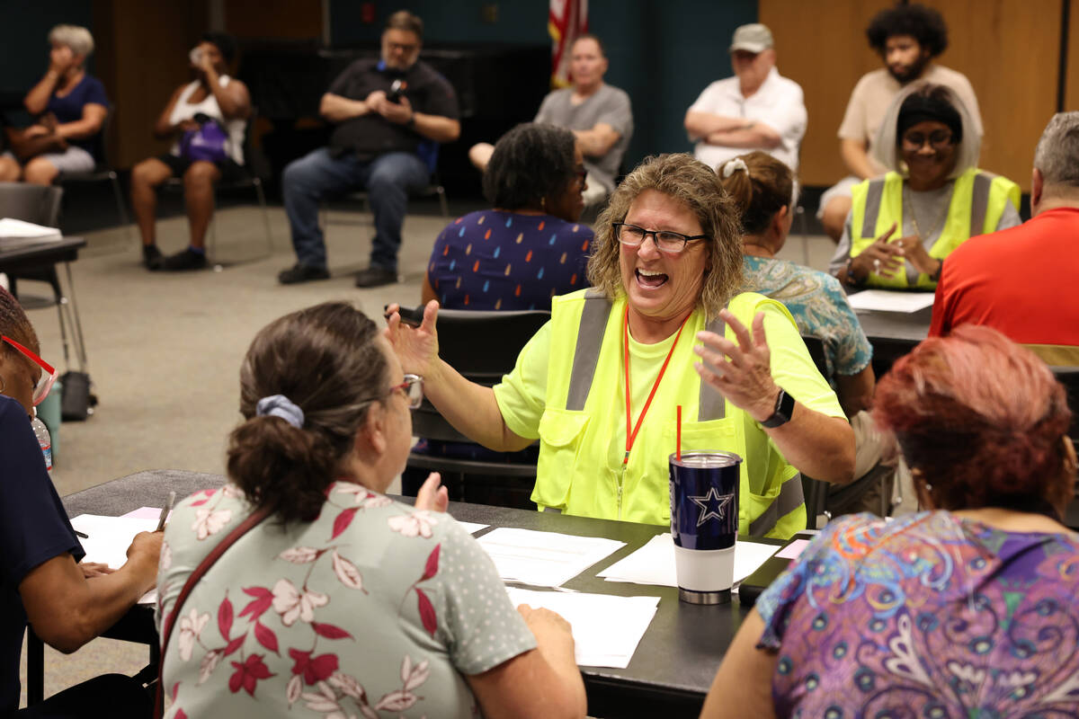 Connie Ames with All City Management Services helps, from left, Ann Rhodes, Karen Trinko and Pa ...