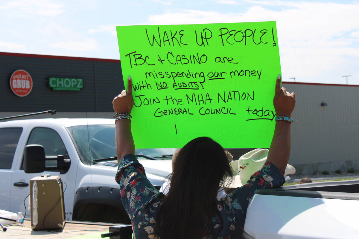 A woman holds a sign at a protest near the 4 Bears casino and MHA Nation tribal administration ...