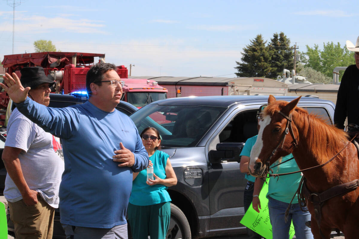 MHA Nation tribal council member Robert White, left, gestures to people at a protest against MH ...