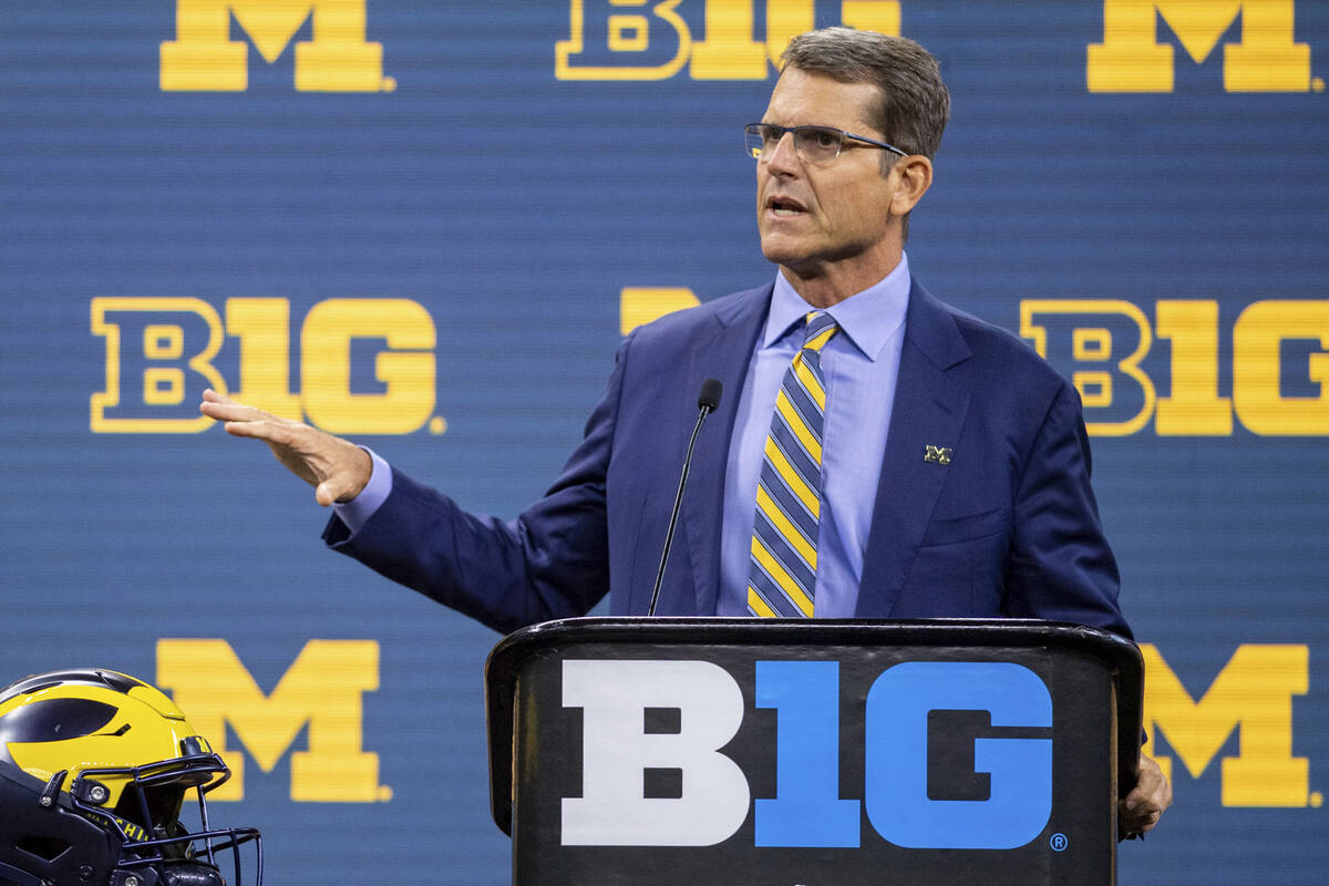 FILE - Michigan head coach Jim Harbaugh speaks during an NCAA college football news conference ...